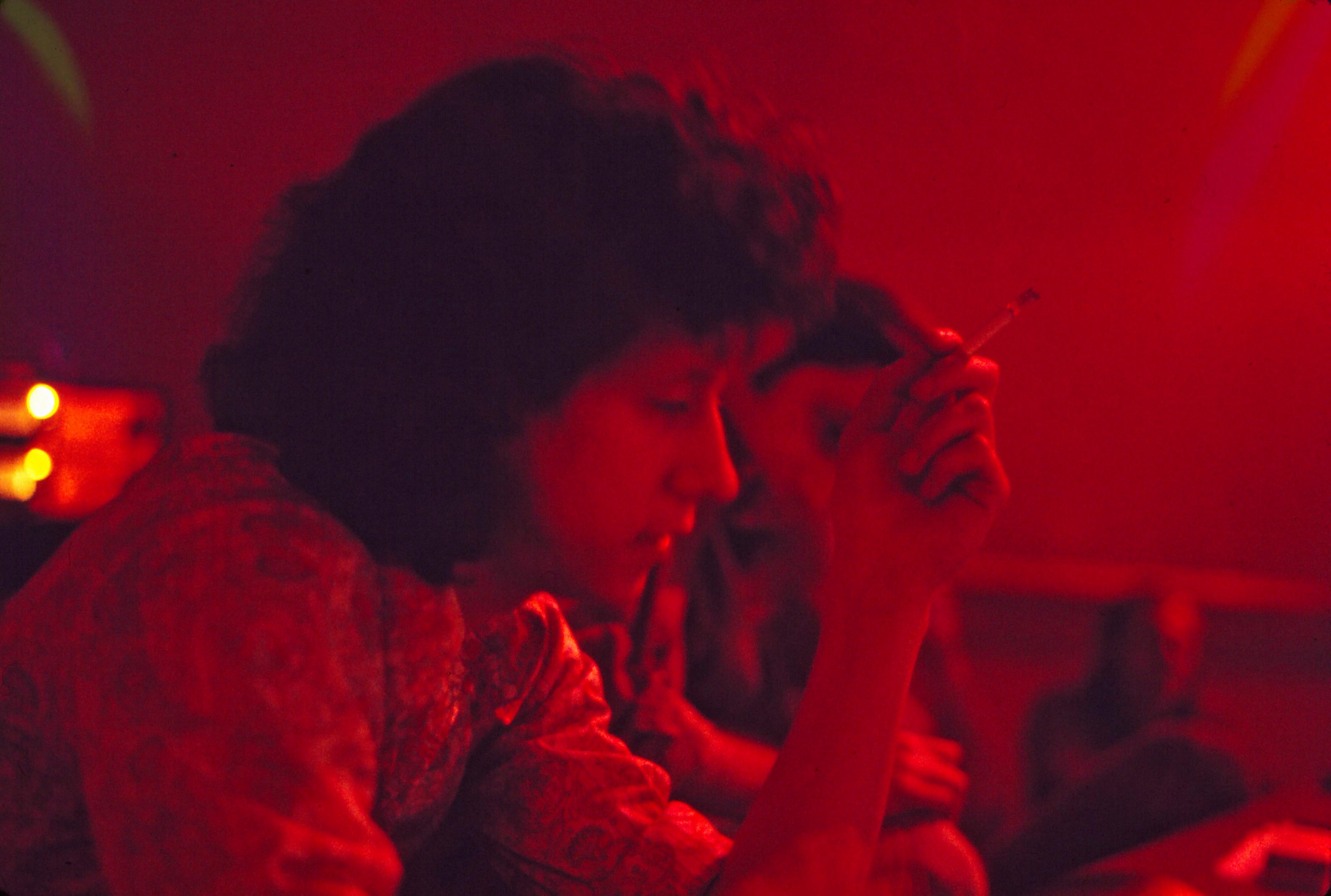 Arlo Guthrie with cigarette (under red light) working at Sunwest Studio